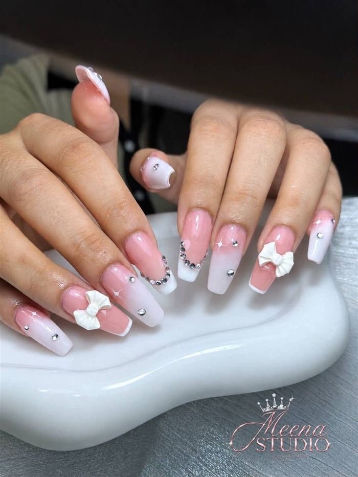Pink to white ombre coffin nails with 3D bows and crystals