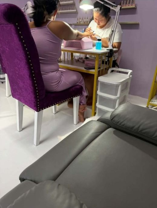 Nail technician working on a client's nails